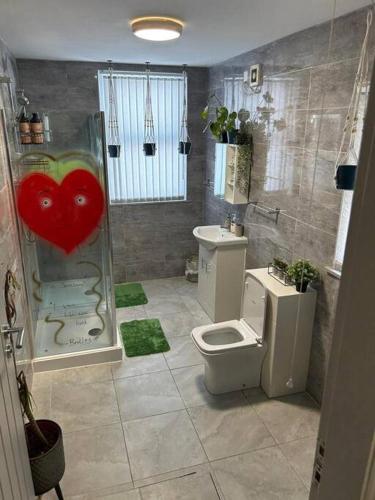 a bathroom with a toilet and a heart on the shower at 2-Bedroom Flat w/ En-Suites, Perfect for Groups in Liverpool