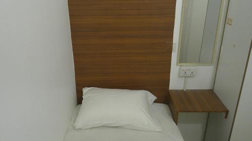 a small bedroom with a bed and a mirror at Ruby Star Hostel Dubai G P-34567 in Dubai