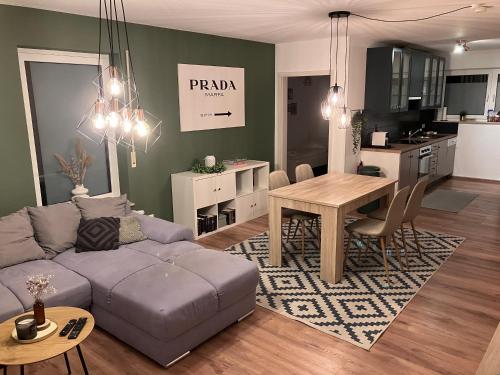 a living room with a couch and a table at Ferienwohnung Talblick in Beffendorf