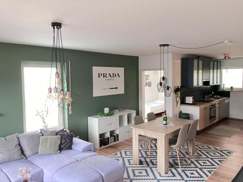 a living room with a couch and a table at Ferienwohnung Talblick in Beffendorf