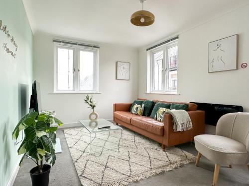 a living room with a couch and a chair at Luxury 2 Bedroom City Centre Apartment - Secure Parking - Amazing location! in Canterbury