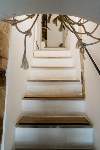 a set of stairs in a house with a mirror at Le Contrade Chiasso Cafaro in Monopoli