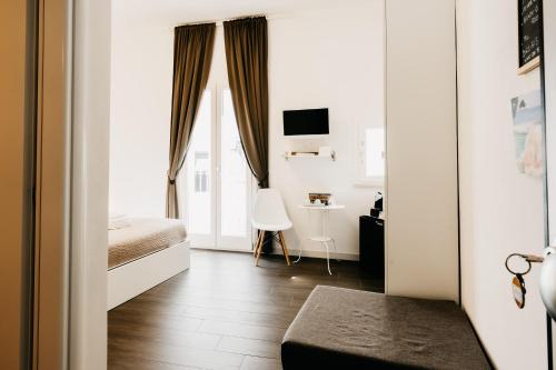 a bedroom with a bed and a desk in a room at Le Contrade Vico Alba in Monopoli
