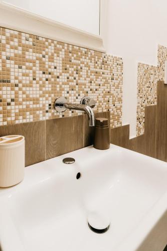 a bathroom sink with a faucet on top of it at Le Contrade Vico Alba in Monopoli
