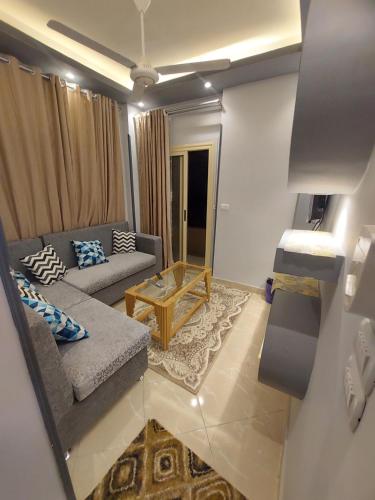 a living room with a couch and a table at Luxor apartment in Luxor