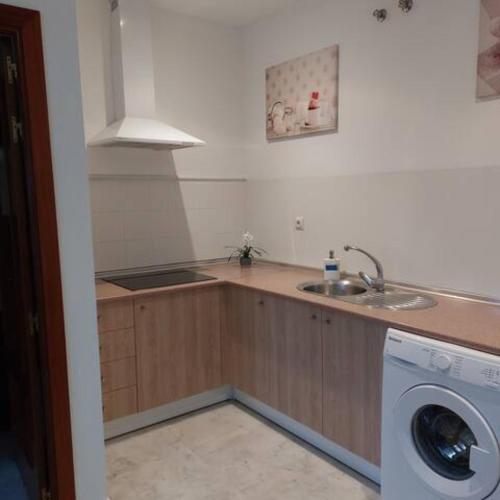 a kitchen with a sink and a washing machine at IJD apartments 126 PARKING GRATIS Y PISCINA in Bormujos