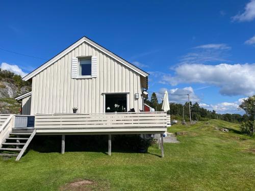 a large white house with a large porch at Sjarmerende og romslig bolig, omgitt av vakker natur in Molde