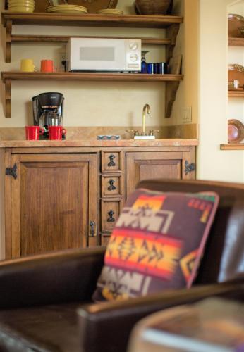 a kitchen with a counter with a microwave and a chair at Blue Lake Ranch in Hesperus