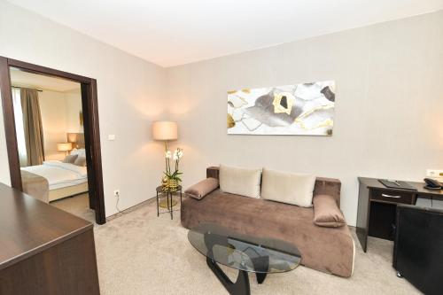 a living room with a couch and a desk at Art Plaza Hotel in Sofia