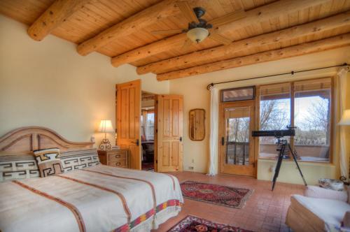 a bedroom with a large bed and a wooden ceiling at Blue Lake Ranch in Hesperus
