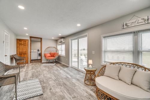 a living room with a couch and a table at Auburn Finger Lakes Farmhouse with Open Views! in Auburn