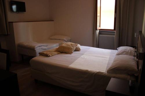 a bedroom with two beds in a room at Albergo Ristorante Bismantova in Castelnovo neʼ Monti