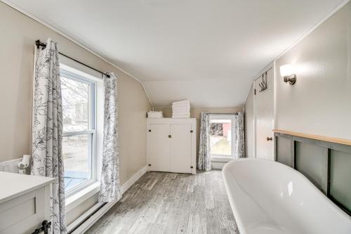 a bathroom with a tub and a window at Auburn Finger Lakes Farmhouse with Open Views! in Auburn