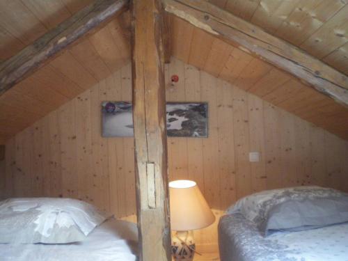 an attic bedroom with a bed and a lamp at Propriete de 2 chambres avec wifi a Taninges a 7 km des pistes in Taninges