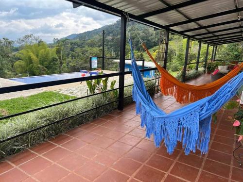 a hammock on the balcony of a house at Finca Aguadalupe, Lago Calima in Calima