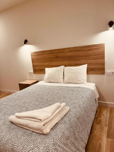 a bedroom with a bed with a towel on it at OIZPE GERNIHOST en Urdaibai in Guernica y Luno