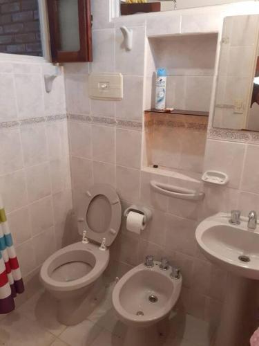 a bathroom with a toilet and a sink at Departamento Noemí in La Cumbre