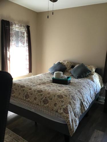 a bedroom with a bed with two books on it at Donna’s Sunset Meadow in Loudon