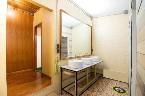 two sinks in a bathroom with a mirror at Cozy Hub Hostel in Chiang Mai
