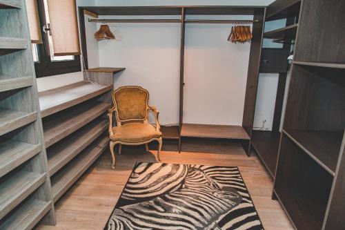 a room with a chair and a zebra rug at Résidence Villa Branda in Calvi