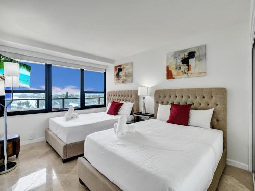 a bedroom with two beds and a window at Beach Resort condo 921 in Miami Beach
