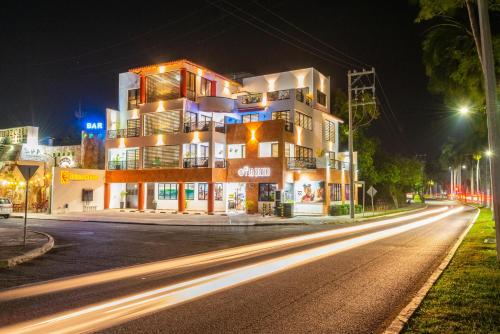 a building on a city street at night at Condominios Brisas del Mar in Santa Cruz Huatulco