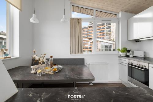 a kitchen with a table with wine glasses on it at Ferienhaus Küstenschatz Marina Wendtorf in Wendtorf