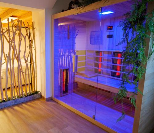 a room with a glass door with purple lights at Haven Spa Luxury Loft - Como City Centre in Como