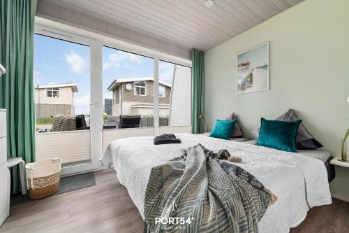 a bedroom with a bed and a large window at Ferienhaus Kleine Düne Marina Wendtorf in Wendtorf