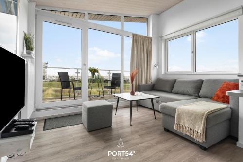 a living room with a couch and a table at Ferienhaus Möwennest Marina Wendtorf in Wendtorf