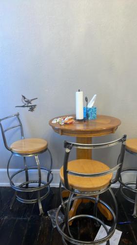 a table with two chairs and a table with a plane on the wall at Springer Station in Springer
