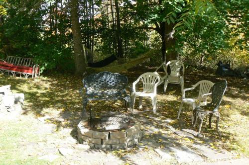 a group of chairs and a fire pit in a yard at Catskill Mountain Retreat in West Kill