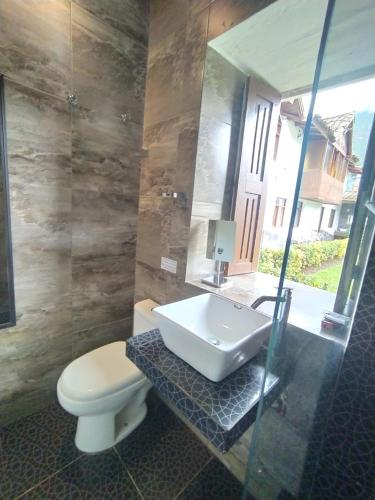 a bathroom with a sink and a toilet at Indavesa Valle Sagrado Collection in Calca