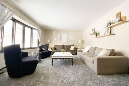 a living room with a couch and a table at King Beds, Sleeps 11, *Entertainment Included!* in Burnsville