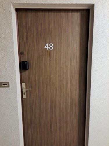 a wooden door with the number on it at Studio tout confort avec place de parking et wifi in Balaruc-les-Bains