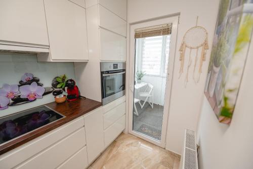 a kitchen with white cabinets and a counter top at Apartma Golob in Maribor