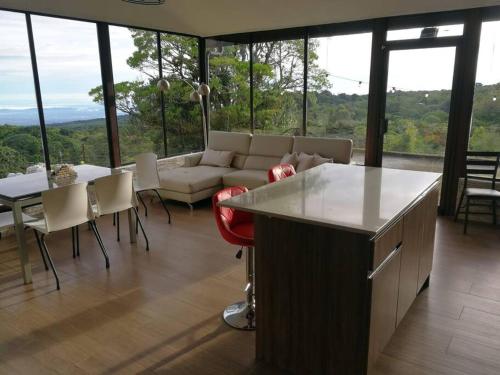 a living room with a couch and a table at La Cabaña in Heredia