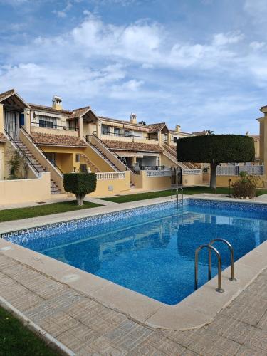 a large swimming pool in front of a building at Sandy Bunker 2 bed apartment and pool in Alicante