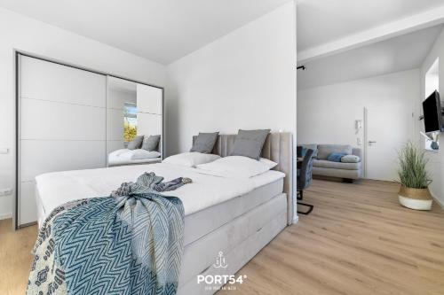 a bedroom with a large bed with a large mirror at Strandgut Gelting in Gelting