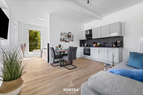 a living room with a couch and a table at Strandgut Gelting in Gelting