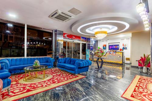 a lobby with blue couches and a table at Dem İstanbul Airport Hotel in Istanbul