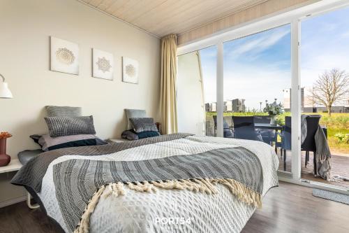 Postel nebo postele na pokoji v ubytování Ferienhaus Kleine Sonne Marina Wendtorf