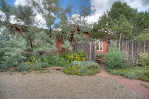 a garden in front of a house with a fence at Blue Lake Ranch in Hesperus