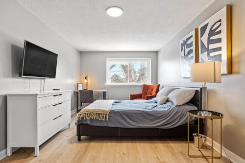 a bedroom with a bed and a flat screen tv at 14 minutes from downtown, Luxury home in Nepean in Ottawa