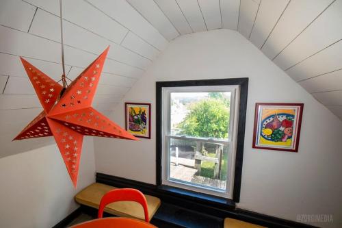 a star chandelier in a room with a window at Crow's Nest Crash-Pad in Homestead