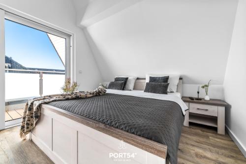 a bedroom with a bed and a large window at Ferienwohnung Insellodge Fehmarn in Fehmarn
