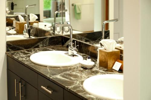 a bathroom with two sinks and two faucets at Blue Lake Ranch in Hesperus