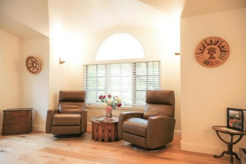 two chairs and a table in a room with a window at Blue Lake Ranch in Hesperus