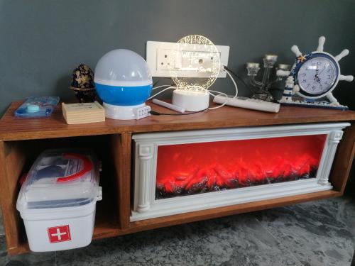 a wooden table with a red fireplace in a room at NHC full cottage in Nandi