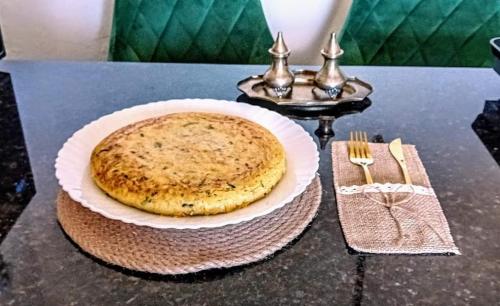 a table with a pie on a plate on a table at Posada Puente Romano in Sedella